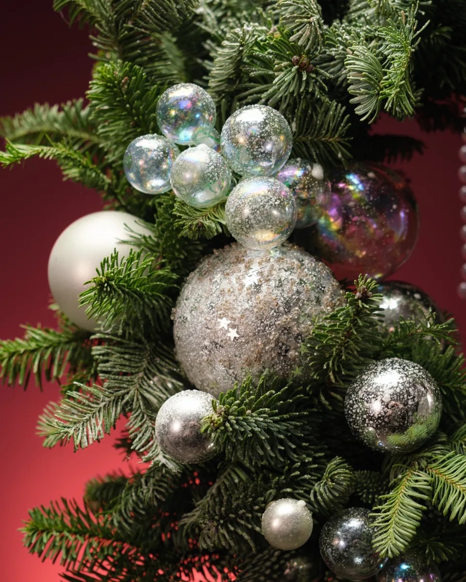 A student's hands assembling a Christmas piece