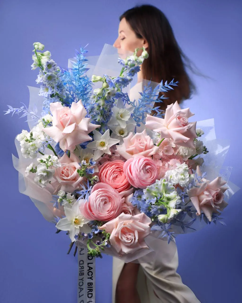 A Lacy Bird spreading bouquet in blue and pink